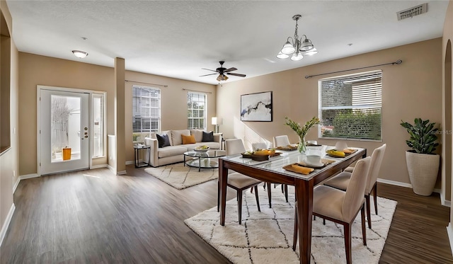 dining area featuring a textured ceiling, wood finished floors, visible vents, and baseboards