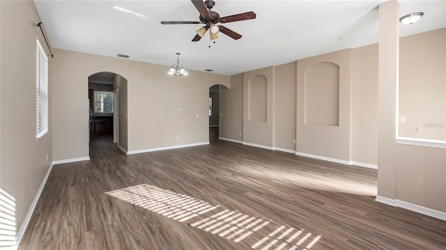 empty room with visible vents, baseboards, wood finished floors, and a ceiling fan