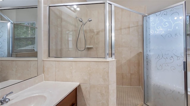 full bathroom featuring vanity and a tile shower