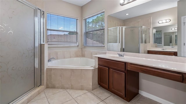 bathroom featuring vanity, tile patterned floors, a bath, and a stall shower