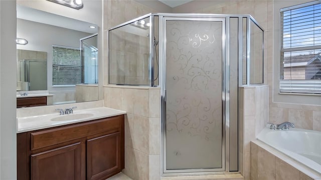 full bath with vanity, a shower stall, a bath, and tile walls