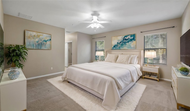 bedroom with multiple windows, baseboards, and light carpet