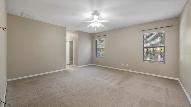 unfurnished room with carpet flooring, baseboards, visible vents, and ceiling fan