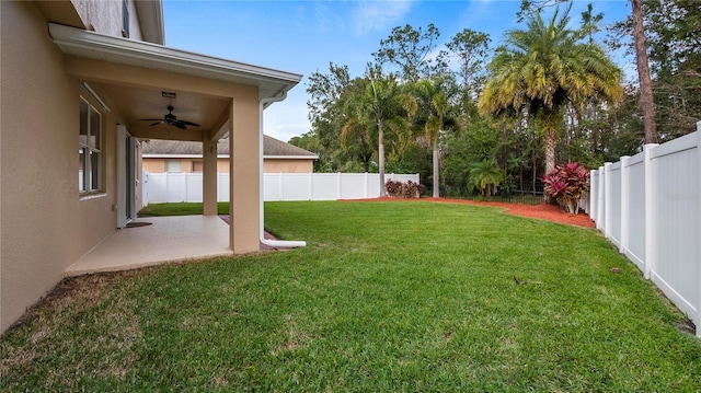 view of yard with a patio, a ceiling fan, and a fenced backyard