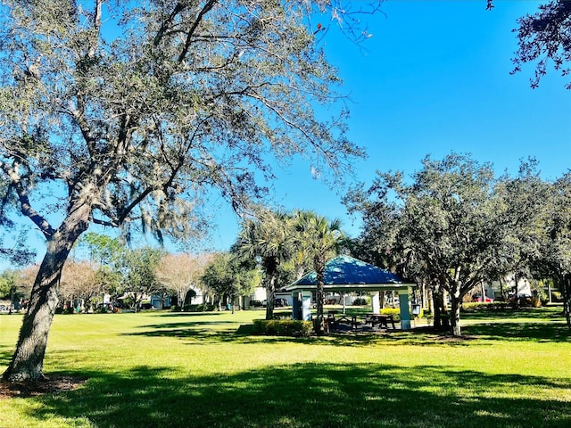 view of property's community with a gazebo and a yard