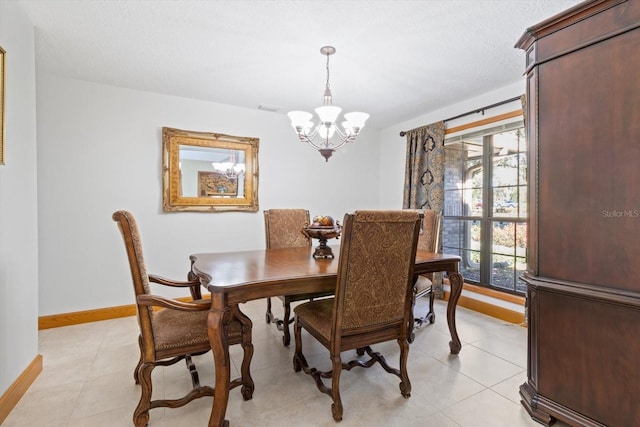 dining space featuring light tile patterned floors, an inviting chandelier, and a healthy amount of sunlight