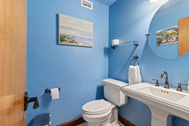 bathroom featuring toilet and sink