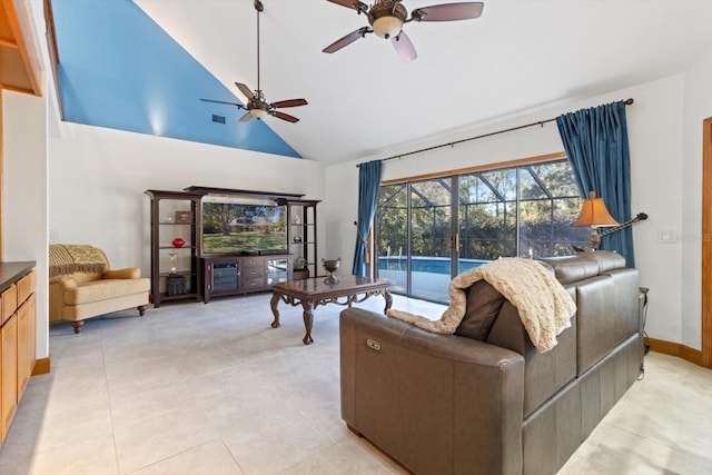 tiled living room with high vaulted ceiling and ceiling fan