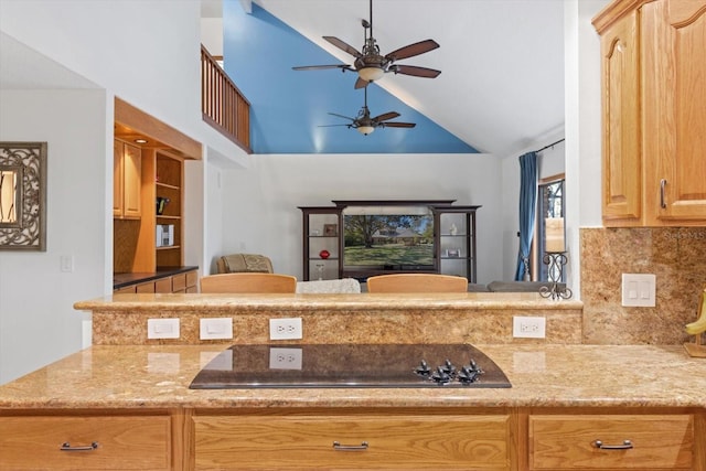 kitchen with kitchen peninsula, black electric stovetop, tasteful backsplash, and lofted ceiling