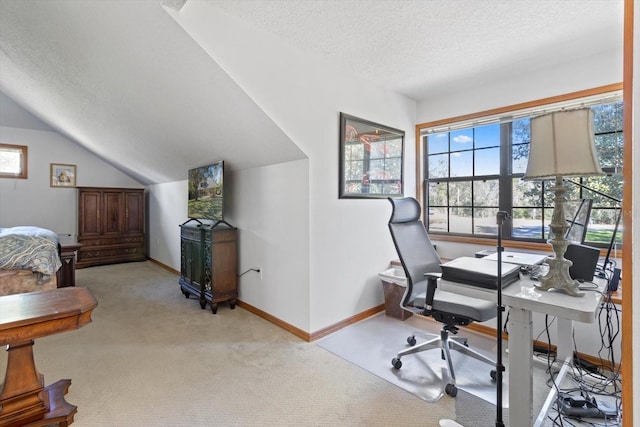 carpeted office featuring a textured ceiling and lofted ceiling