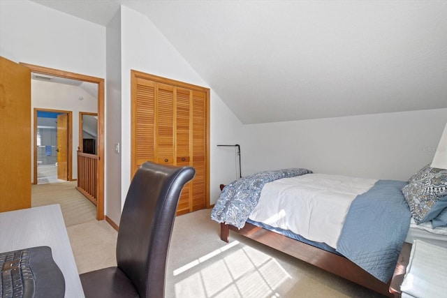 carpeted bedroom featuring a closet and lofted ceiling