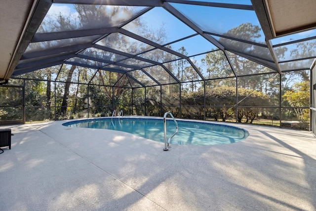 view of swimming pool with glass enclosure and a patio area