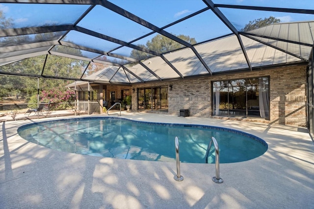 view of swimming pool with a lanai and a patio area