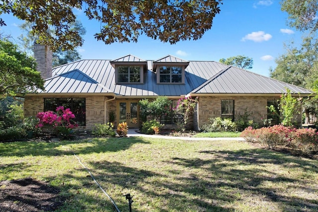 view of front facade featuring french doors and a front lawn