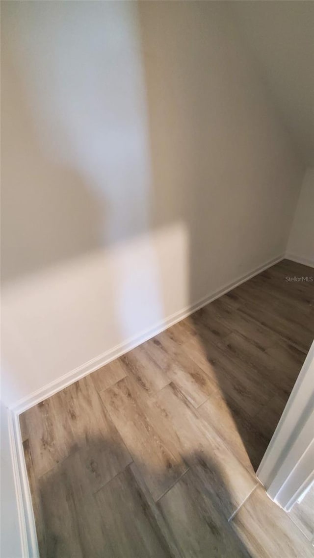 empty room with hardwood / wood-style flooring