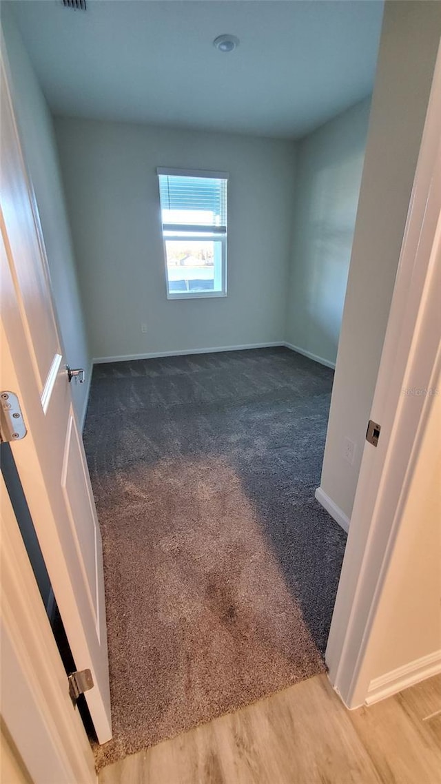 spare room featuring hardwood / wood-style floors