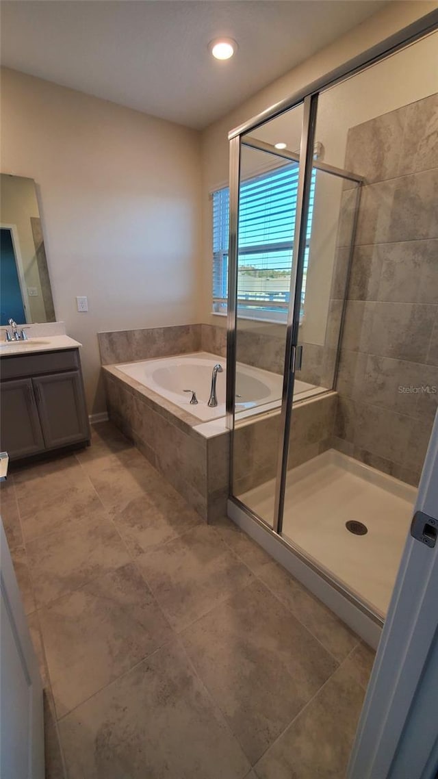 bathroom with vanity, shower with separate bathtub, and tile patterned flooring