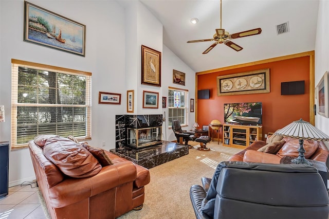 tiled living room with a fireplace, high vaulted ceiling, a wealth of natural light, and ceiling fan