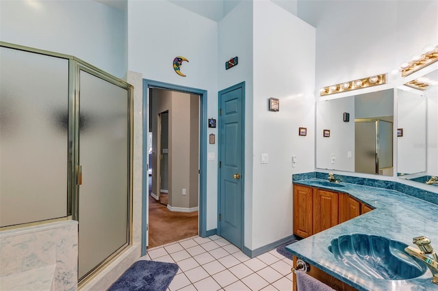 bathroom with tile patterned flooring, vanity, and an enclosed shower