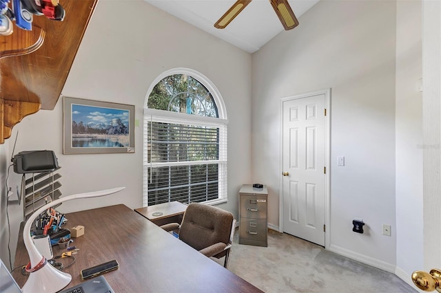 home office with ceiling fan, light colored carpet, and high vaulted ceiling