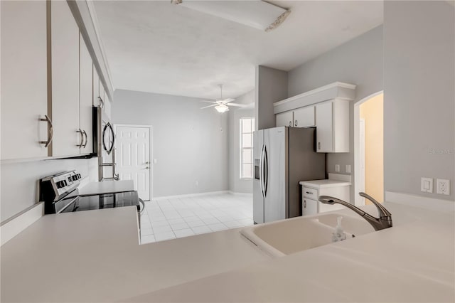 kitchen featuring sink, ceiling fan, appliances with stainless steel finishes, white cabinetry, and light tile patterned flooring