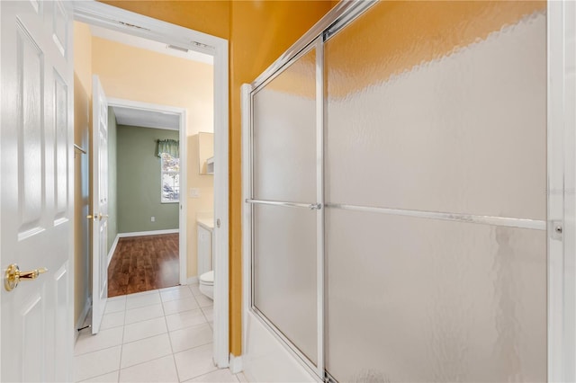 full bathroom with tile patterned flooring, vanity, shower / bath combination with glass door, and toilet