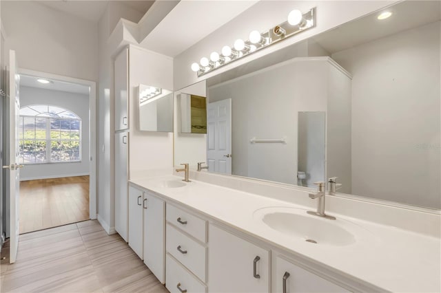 bathroom with vanity, tile patterned flooring, and toilet