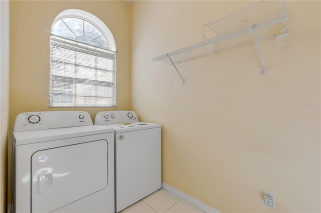 laundry room featuring light tile patterned floors and washer and clothes dryer