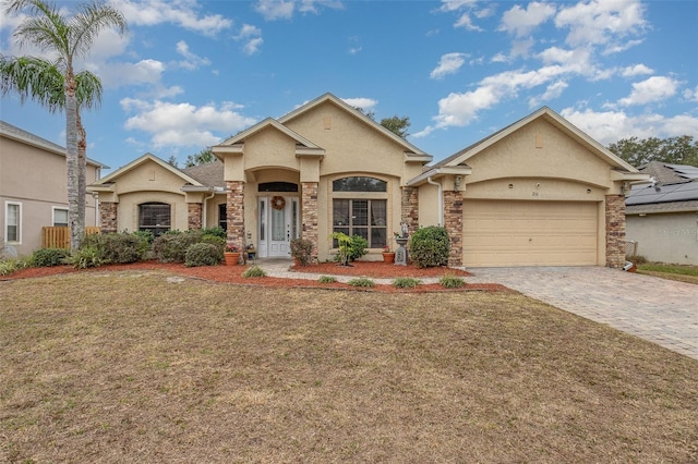 view of front of house with a garage and a front lawn