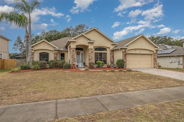 single story home featuring a garage and a front lawn