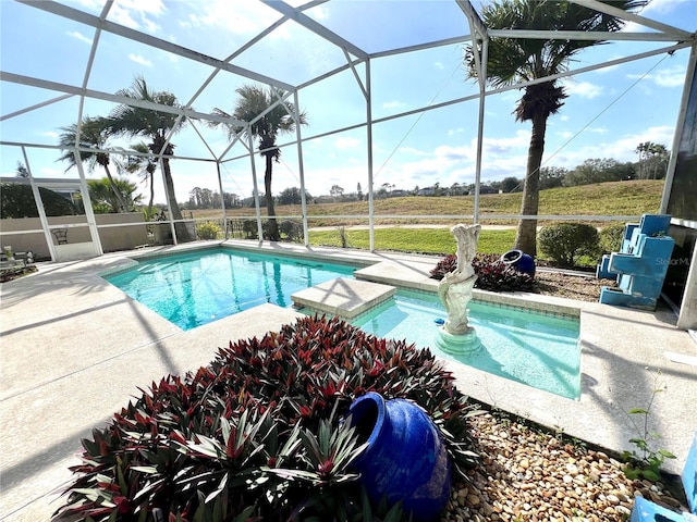 view of swimming pool with a lanai, a patio area, and a rural view