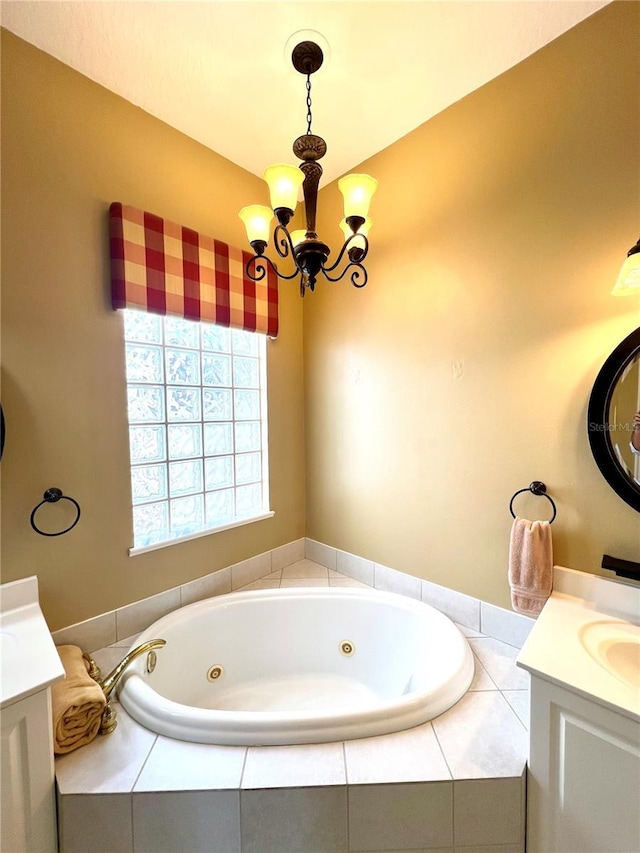 bathroom with vanity, a relaxing tiled tub, and an inviting chandelier