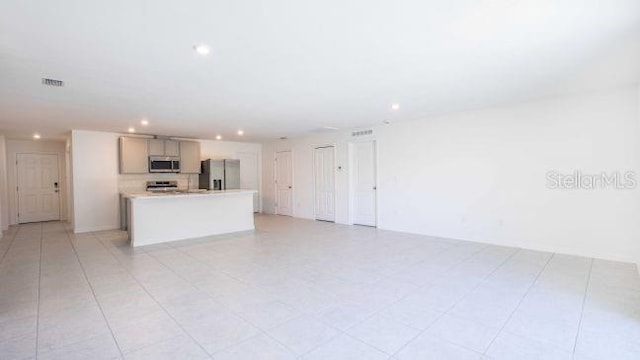 unfurnished living room featuring light tile patterned flooring