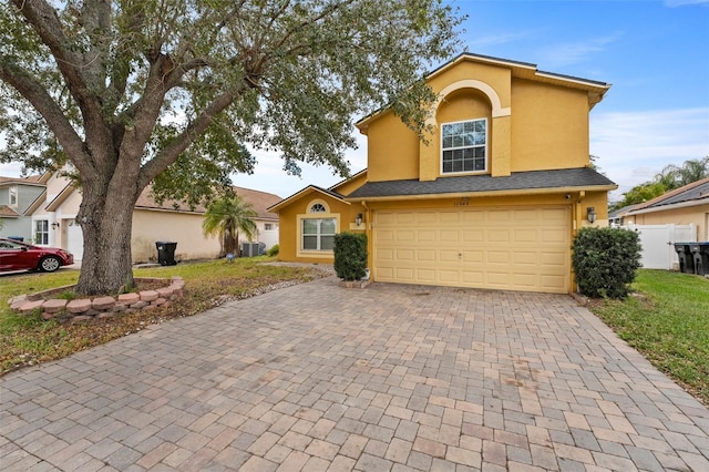 view of front of house featuring central AC unit and a garage