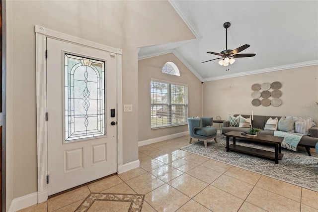 tiled entrance foyer featuring ceiling fan, ornamental molding, and vaulted ceiling