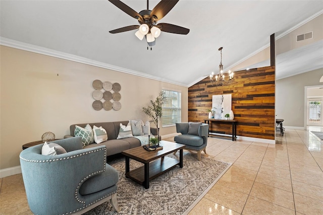 tiled living room featuring a wealth of natural light, lofted ceiling, ceiling fan with notable chandelier, and wooden walls