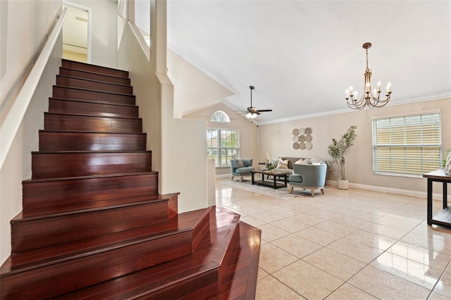 stairs with lofted ceiling, ceiling fan with notable chandelier, tile patterned floors, and crown molding