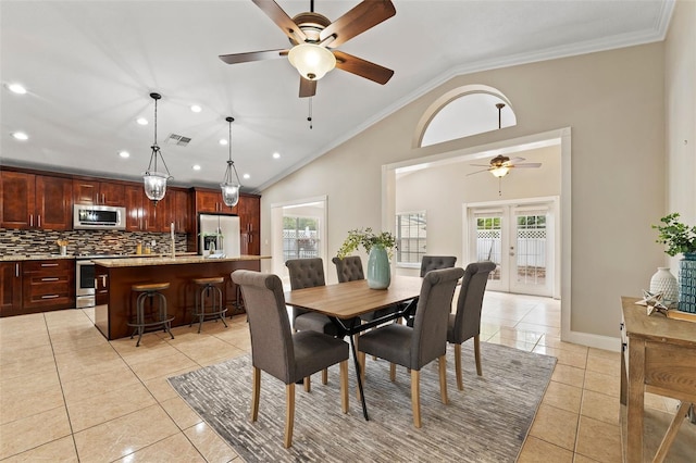 tiled dining area featuring crown molding, french doors, ceiling fan, and vaulted ceiling