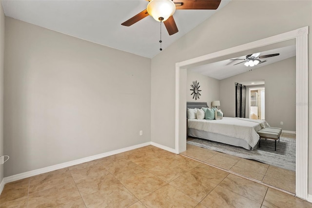 unfurnished bedroom with ceiling fan, light tile patterned flooring, and vaulted ceiling