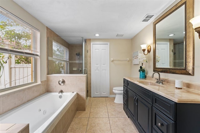 full bathroom featuring tile patterned floors, vanity, independent shower and bath, and toilet