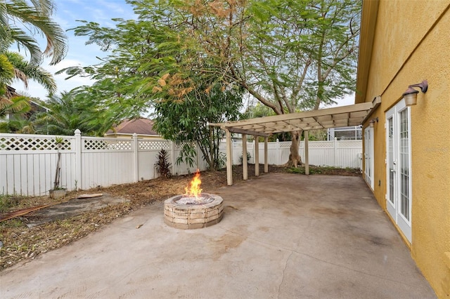 view of patio with a pergola and an outdoor fire pit