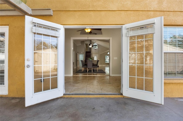 entrance to property featuring ceiling fan