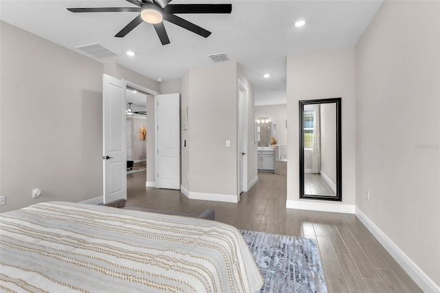 bedroom featuring ceiling fan, ensuite bath, and wood-type flooring