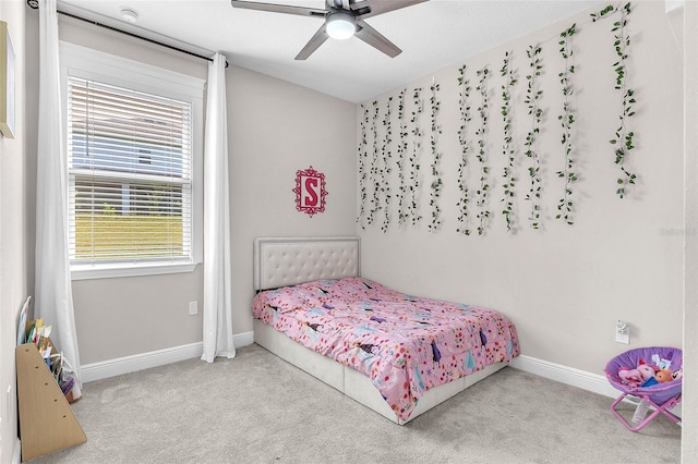 carpeted bedroom with ceiling fan and multiple windows