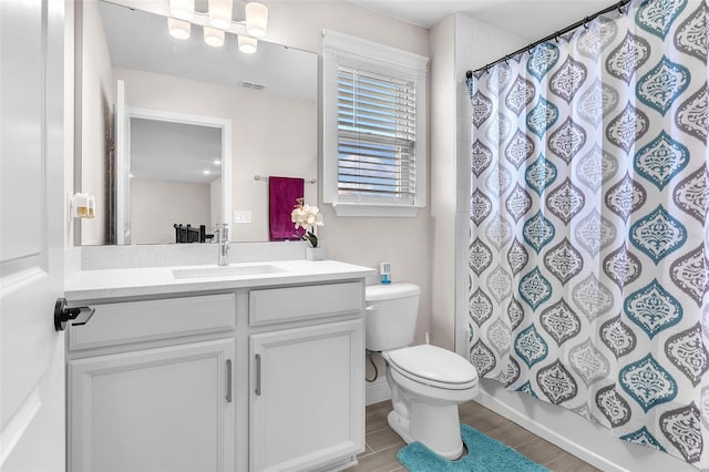 full bathroom with toilet, vanity, and shower / bath combination with curtain