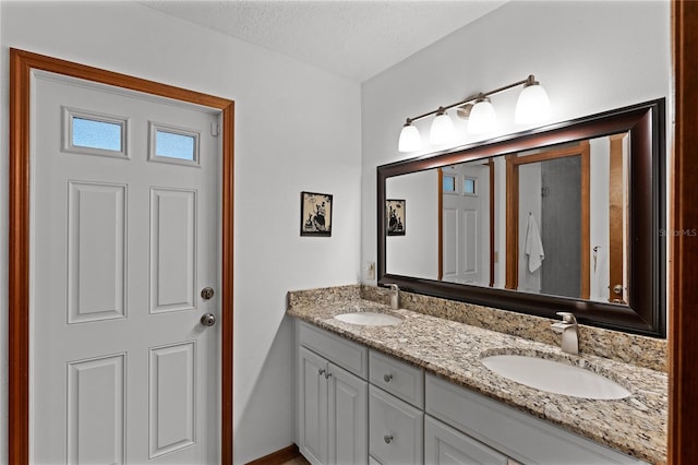 bathroom featuring vanity and a textured ceiling