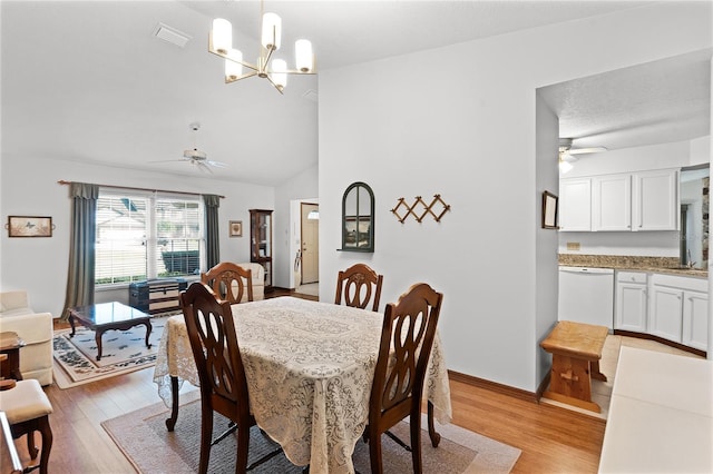 dining space with lofted ceiling, light hardwood / wood-style floors, and ceiling fan with notable chandelier