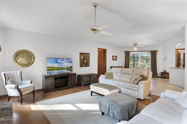 living room featuring light hardwood / wood-style floors, ceiling fan, and lofted ceiling