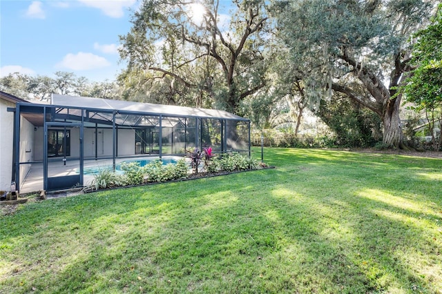 view of yard with glass enclosure