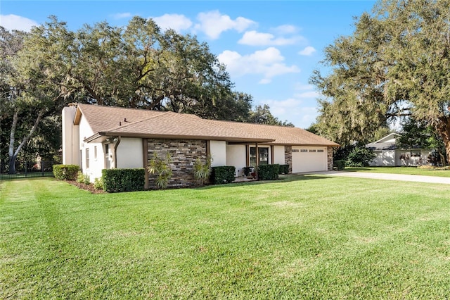 ranch-style home featuring a garage and a front lawn